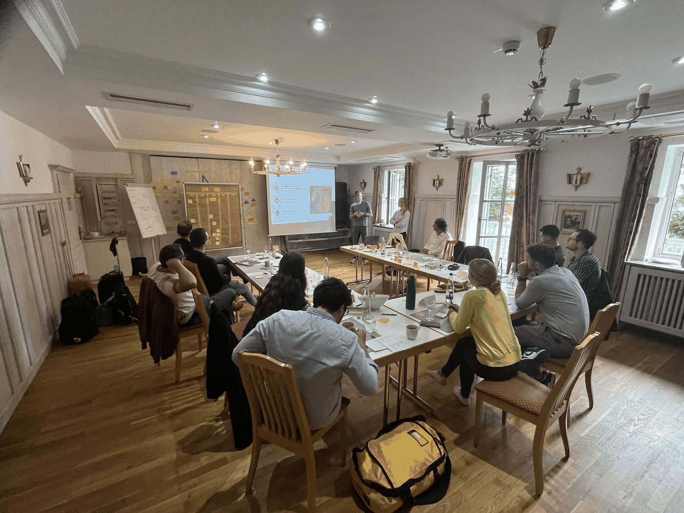 Kuma Partners board offsite session with facilitators addressing the full room