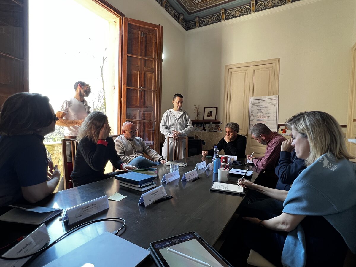 Leadership team seated around a table during a facilitated peer accountability session