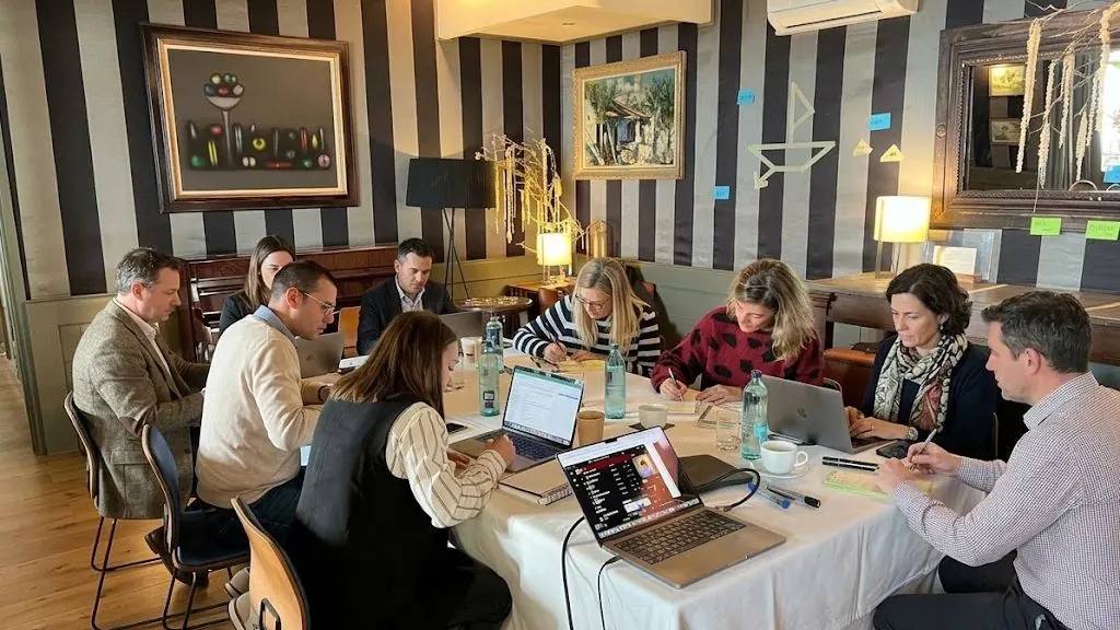 Executive leadership team engaged in a strategic offsite working session on the Costa Brava