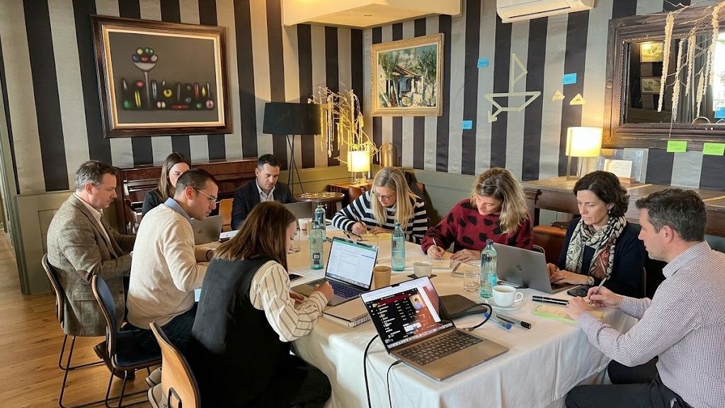 Executive leadership team engaged in strategic offsite working session on the Costa Brava